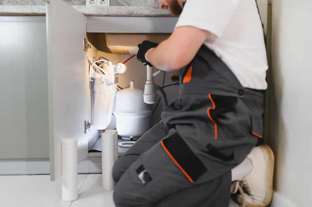 plumber work uniform inspecting repairing water