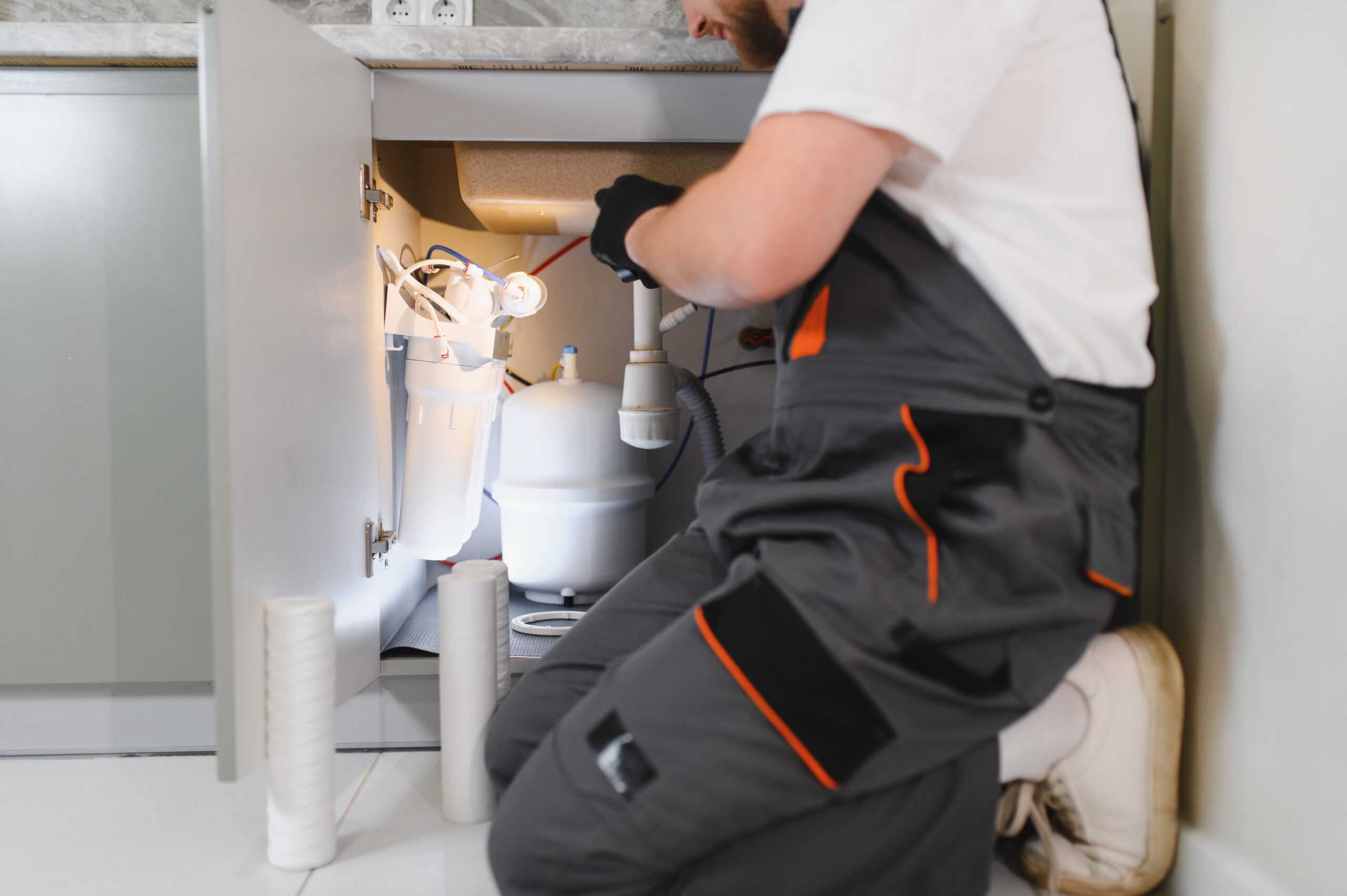 plumber work uniform inspecting repairing water
